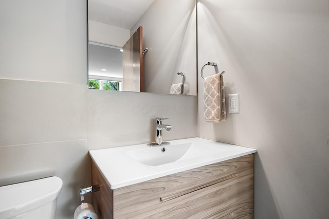 bathroom featuring toilet and vanity