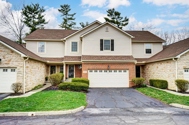 3995 Kensingwood Dr, Columbus, OH 43230 - traditional-style house featuring roof with shingles, a garage, brick siding, and aphalt driveway