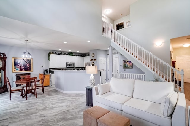 3995 Kensingwood Dr, Columbus, OH 43230 - living area featuring stairs, a high ceiling, recessed lighting, and a notable chandelier