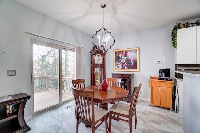 3995 Kensingwood Dr, Columbus, OH 43230 - dining space featuring marble finish floor, baseboards, and an inviting chandelier