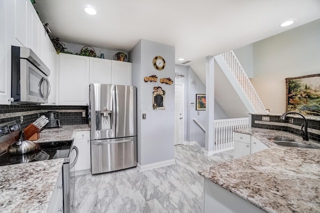 3995 Kensingwood Dr, Columbus, OH 43230 - kitchen featuring a sink, white cabinetry, tasteful backsplash, stainless steel appliances, and marble finish floor