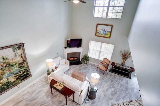 3995 Kensingwood Dr, Columbus, OH 43230 - bedroom featuring a fireplace with flush hearth, baseboards, ceiling fan, and a high ceiling