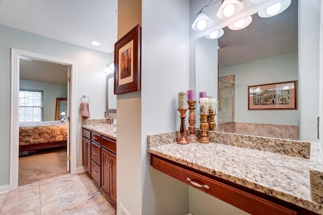 3995 Kensingwood Dr, Columbus, OH 43230 - ensuite bathroom with baseboards, vanity, ensuite bath, and a textured ceiling