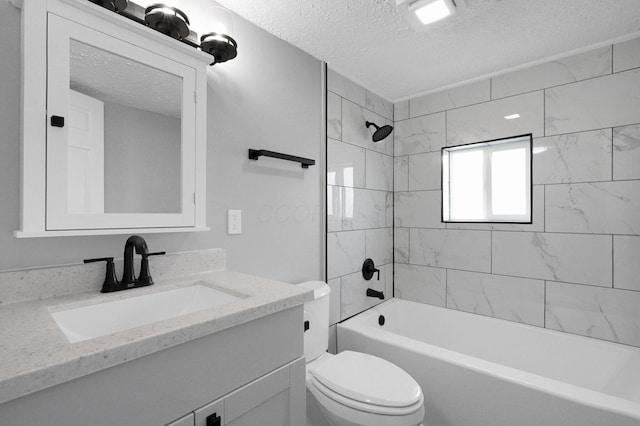 full bath with toilet, shower / bathing tub combination, vanity, and a textured ceiling