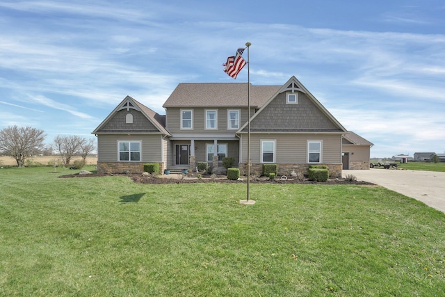 craftsman-style home with stone siding and a front yard
