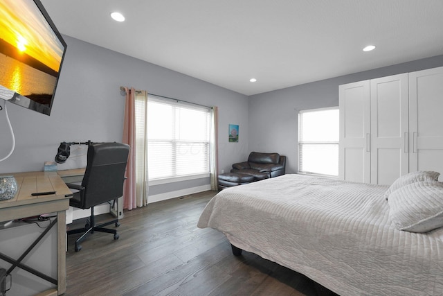 bedroom with baseboards, wood finished floors, and recessed lighting