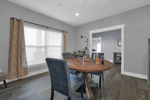 dining room with baseboards and recessed lighting