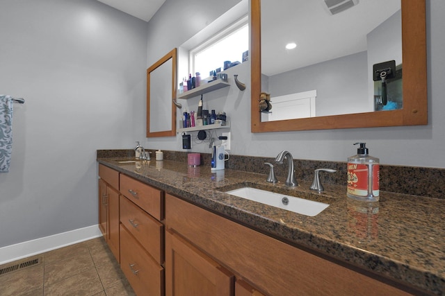 full bathroom with baseboards, tile patterned floors, a sink, and visible vents