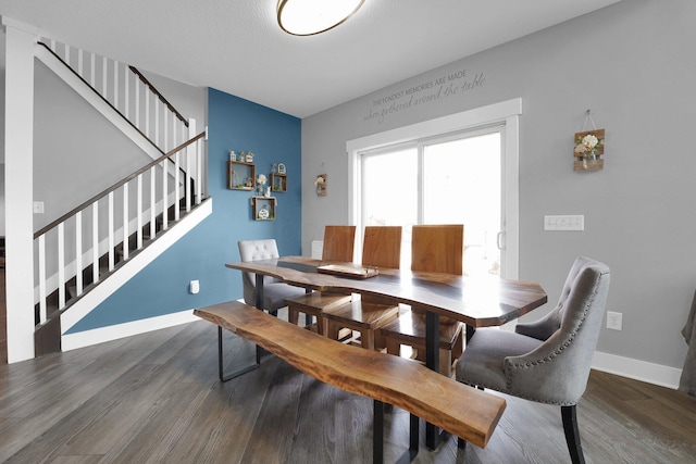 dining area with stairway, baseboards, and wood finished floors