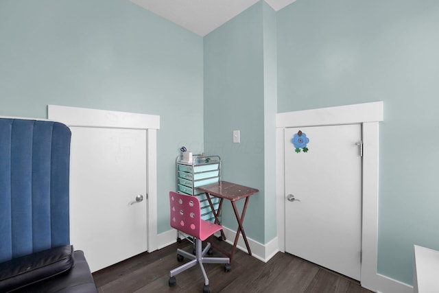 miscellaneous room featuring baseboards and wood finished floors