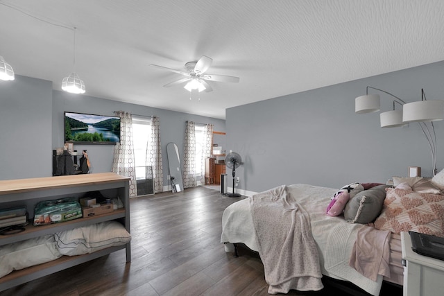 bedroom with baseboards, ceiling fan, and dark wood finished floors