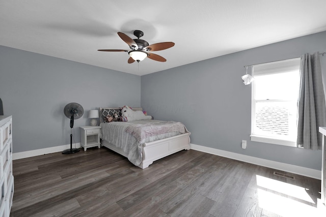 bedroom with baseboards, a ceiling fan, dark wood-type flooring, and visible vents