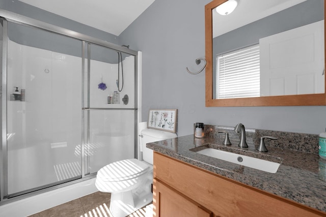 full bathroom featuring a shower stall, toilet, vanity, and tile patterned floors