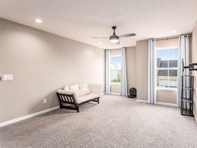 unfurnished room featuring carpet floors, baseboards, ceiling fan, and a wealth of natural light