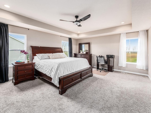 bedroom featuring baseboards, carpet flooring, and multiple windows