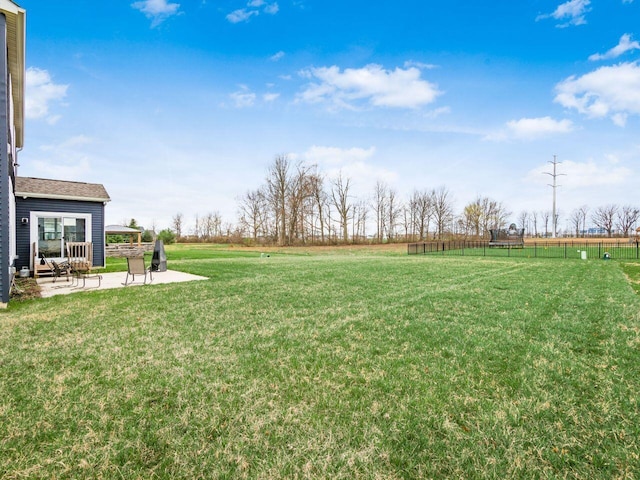 view of yard featuring fence and a patio area