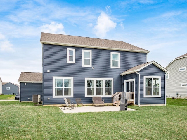 rear view of house with central air condition unit, a patio, and a yard