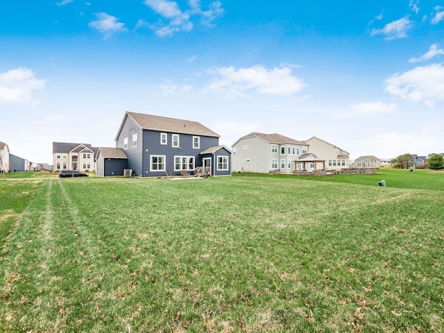 back of property featuring a lawn