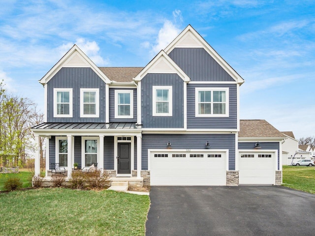 view of front facade featuring stone siding, an attached garage, board and batten siding, aphalt driveway, and a porch