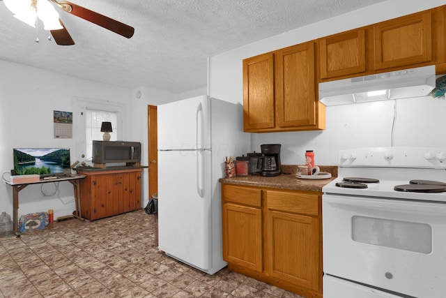 kitchen featuring white appliances, under cabinet range hood, ceiling fan, brown cabinetry, and a textured ceiling