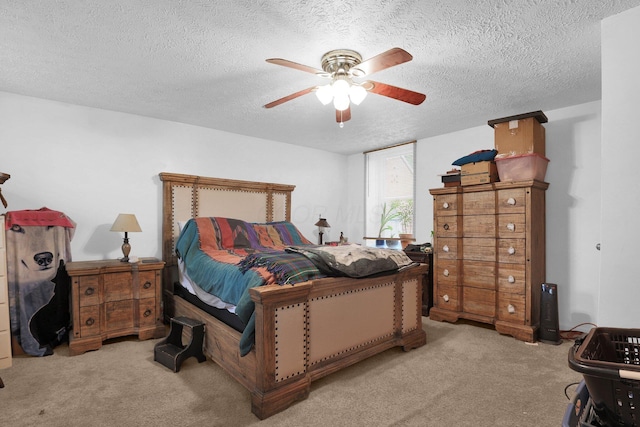 bedroom with carpet flooring, a textured ceiling, and a ceiling fan