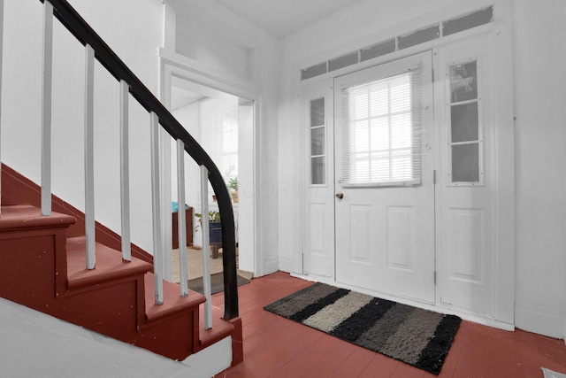 foyer entrance with stairway and wood finished floors