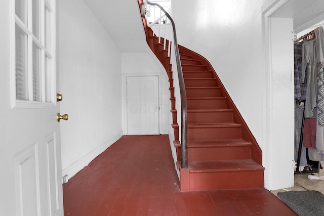 stairs featuring hardwood / wood-style floors