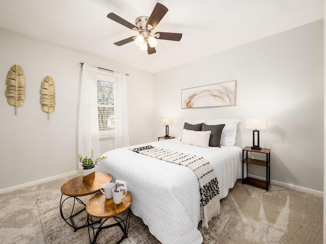 bedroom with baseboards, carpet, and a ceiling fan