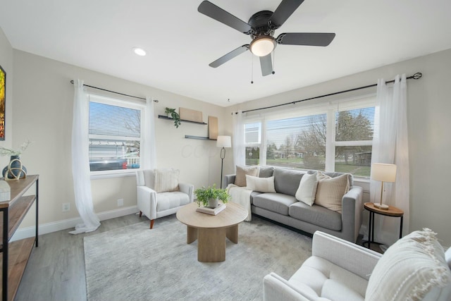 living room featuring recessed lighting, baseboards, ceiling fan, and wood finished floors