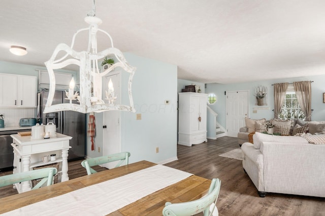 dining area featuring wood finished floors, baseboards, and stairway