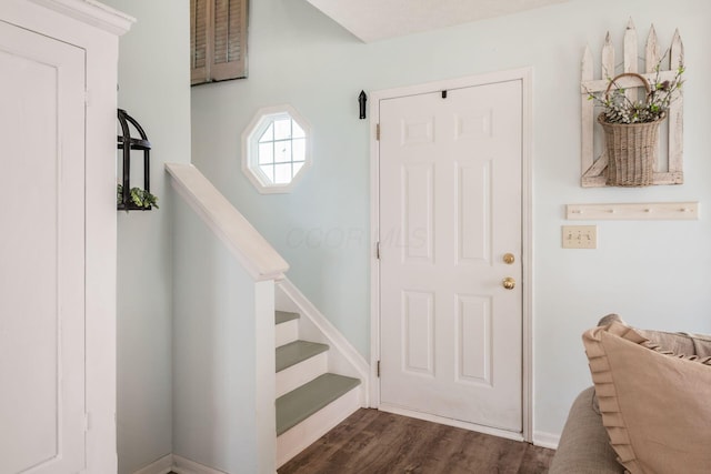 entrance foyer featuring stairs, baseboards, and dark wood finished floors