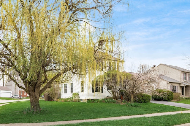 view of front of property featuring driveway and a front lawn