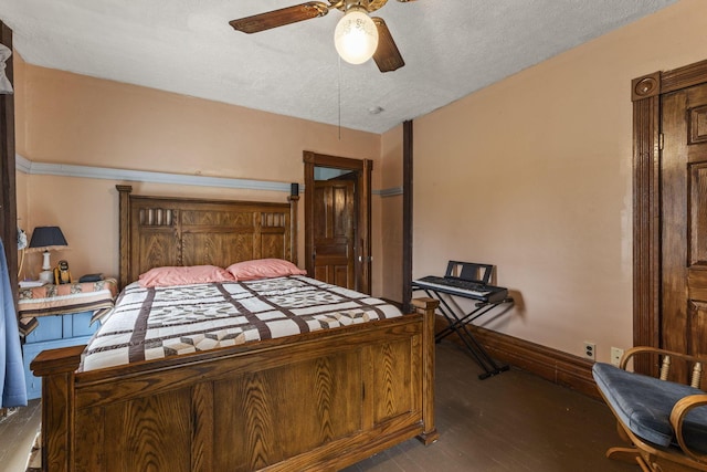 bedroom featuring ceiling fan, baseboards, a textured ceiling, and wood finished floors