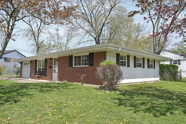 ranch-style house featuring brick siding, a garage, a front lawn, and fence