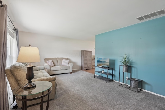 living room with baseboards, carpet flooring, and visible vents