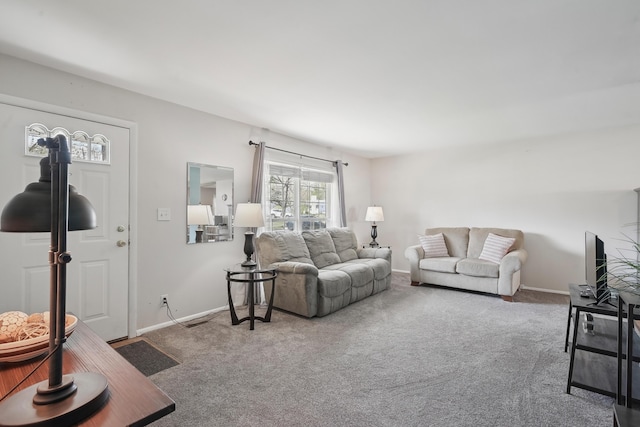 living area with visible vents, baseboards, and carpet