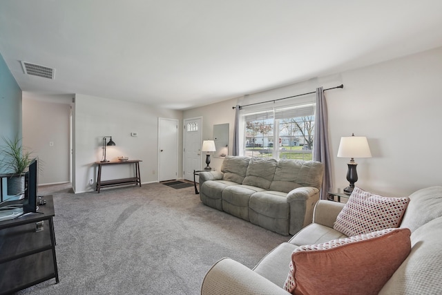 living room featuring carpet floors, visible vents, and baseboards