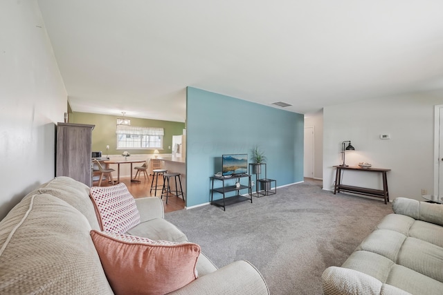 living room featuring visible vents and carpet