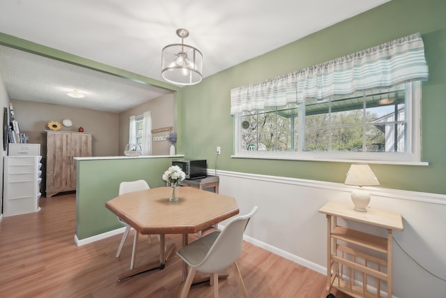 dining room featuring baseboards and wood finished floors