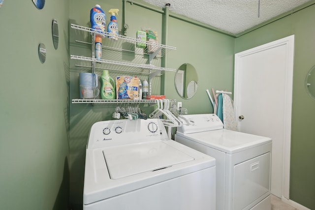 laundry room with a textured ceiling, independent washer and dryer, and laundry area