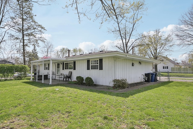 exterior space with fence, a front yard, and a patio