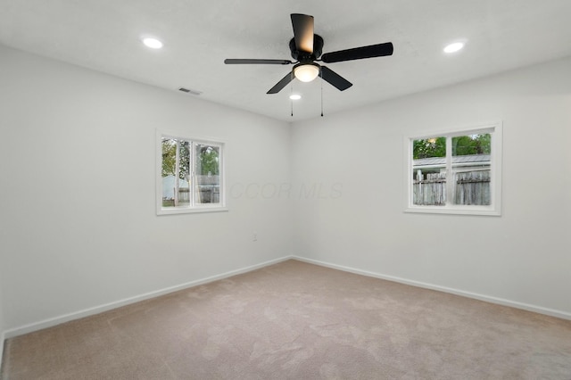 spare room featuring recessed lighting, baseboards, visible vents, and carpet
