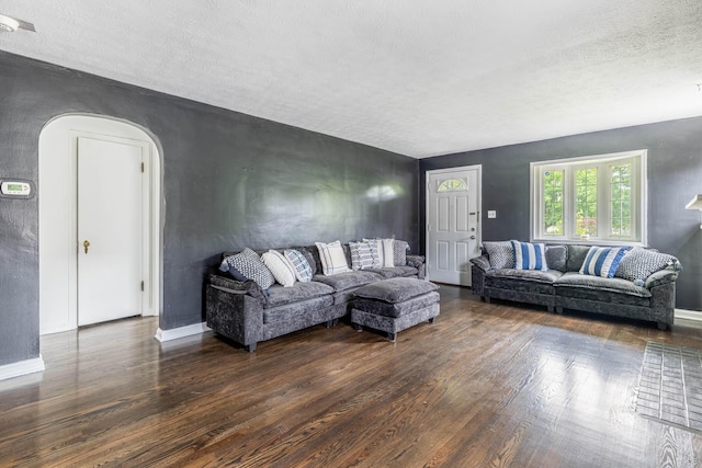 624 W 1st St, Springfield, OH 45504 - living area with wood finished floors, a textured ceiling, arched walkways, and baseboards