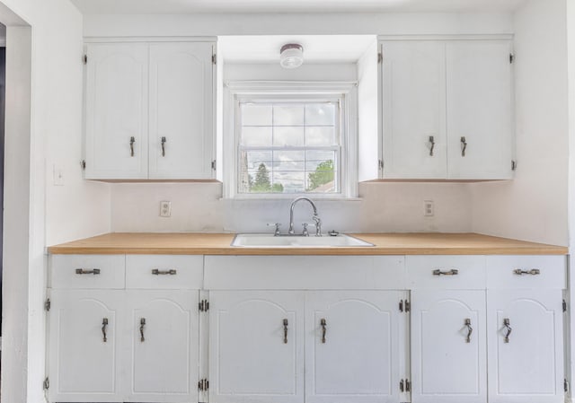 624 W 1st St, Springfield, OH 45504 - kitchen with a sink, white cabinetry, and light countertops