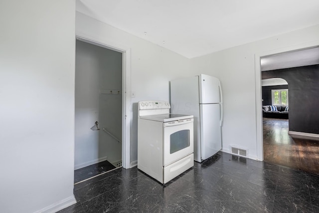624 W 1st St, Springfield, OH 45504 - kitchen with white appliances, baseboards, and arched walkways