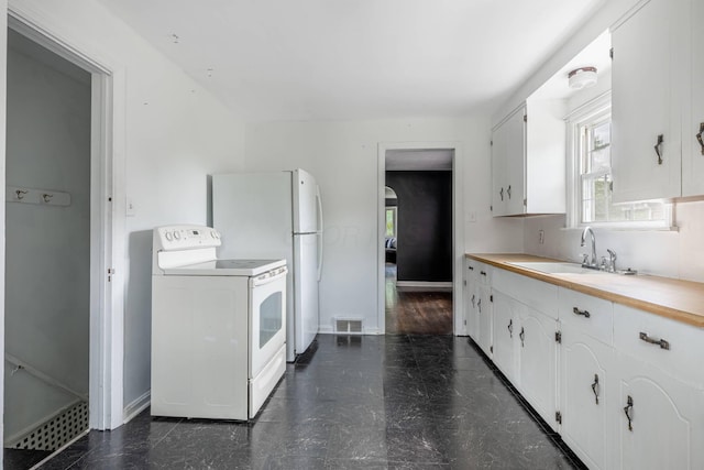 624 W 1st St, Springfield, OH 45504 - kitchen with white appliances, a sink, white cabinets, and light countertops