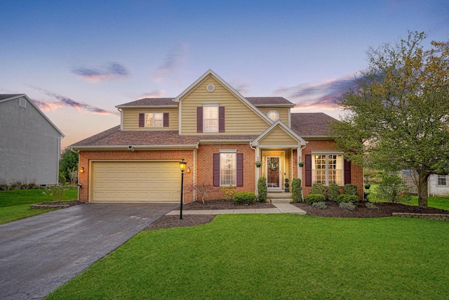 traditional-style home featuring a garage, aphalt driveway, brick siding, and a front lawn