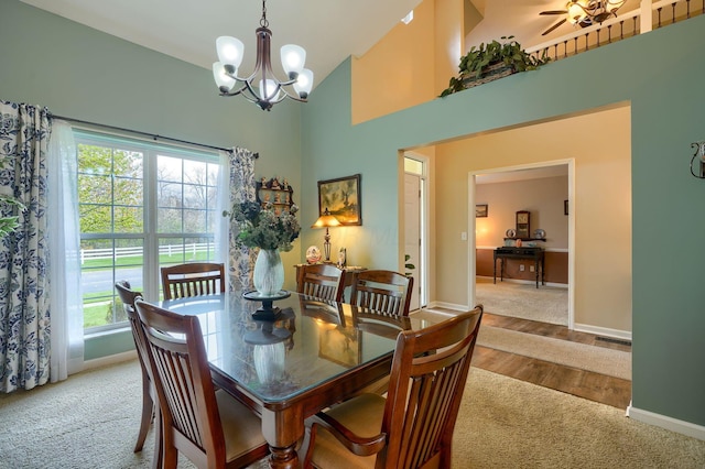 dining space featuring high vaulted ceiling, carpet flooring, visible vents, and baseboards