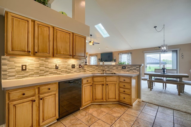 kitchen with vaulted ceiling with skylight, dishwasher, a sink, a peninsula, and light colored carpet