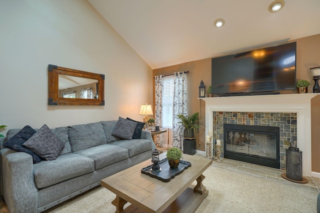 living area featuring a tile fireplace, lofted ceiling, and recessed lighting
